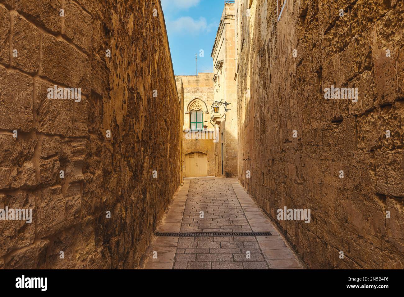 Antica strada acciottolata medievale nella città di Mdina, Malta con nessuno in giornata di sole. Destinazione di viaggio in Europa Foto Stock