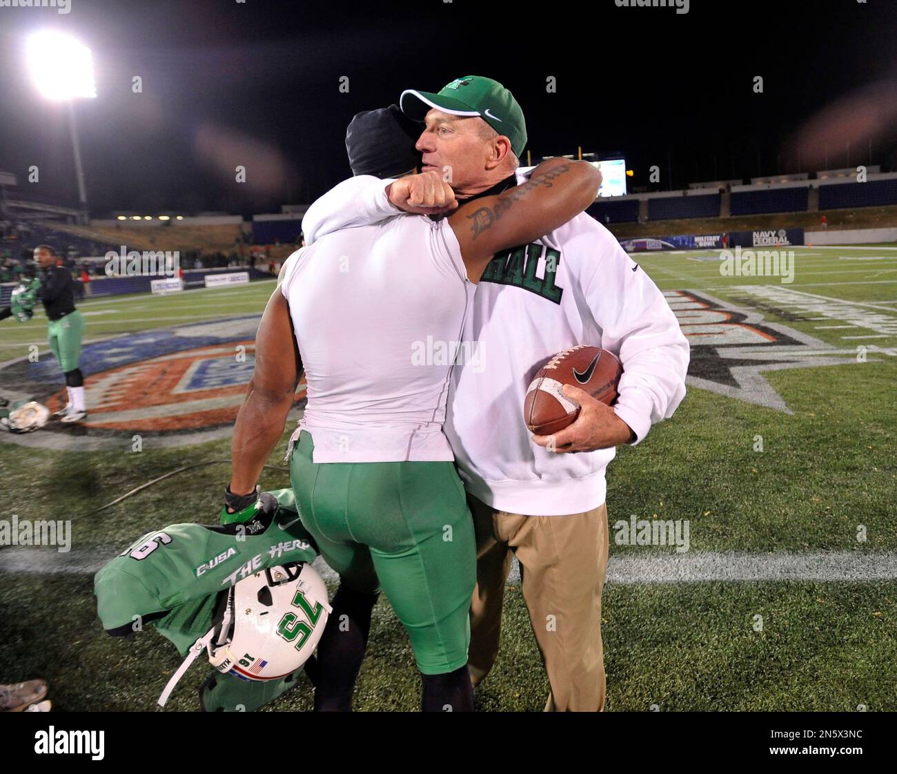 Marshall football coach Doc Holliday hugs running back Essray ...