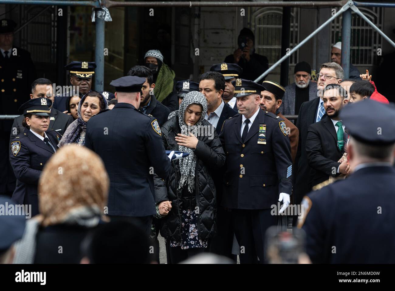 LA moglie DI PO Adeed Fayaz riceve la bandiera ripiegata NYPD ai suoi funerali al Makki Masjid Muslim Community Center di Brooklyn, New York, il 9 febbraio 2023 Foto Stock