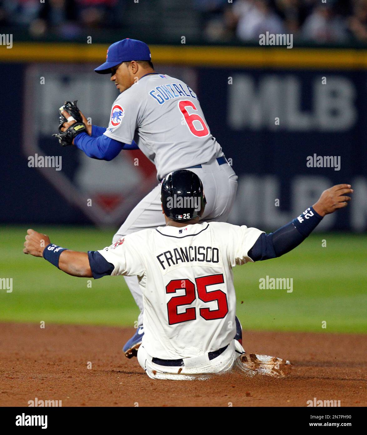 Atlanta Braves' Juan Franciso, bottom, is forced out by Chicago Cubs second baseman Alberto Gonzales during the sixth inning of a baseball game on Saturday, April 6, 2013, in Atlanta. (AP Photo/Butch Dill) Foto Stock