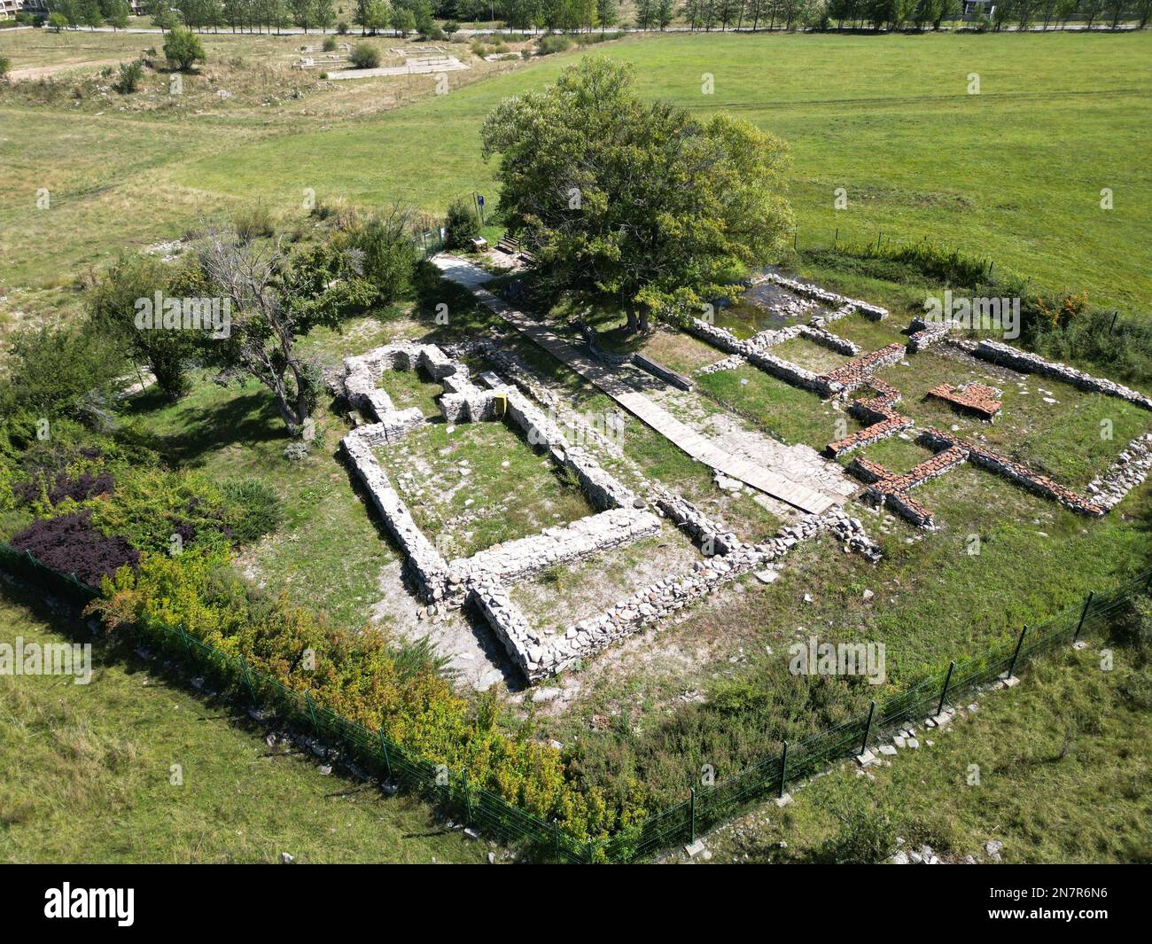 Un'immagine aerea dei resti di un vecchio edificio storico in un campo verde in una giornata estiva Foto Stock