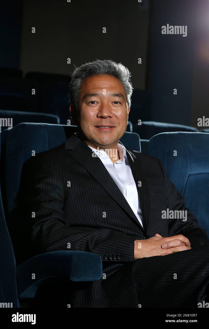 In this Wednesday, Feb. 6, 2013, photo, Kevin Tsujihara, CEO of the Warner Bros., poses for photos in a screening room at the Warner Bros. Studios in Burbank, Calif. On Friday, Feb. 28, 2013, Tsujihara, 48, who grew up making deliveries as the son of egg distributors, will become the CEO of Warner Bros. Entertainment. The third-generation Japanese-American will be the first Asian-American to head a Hollywood studio. (AP Photo/Jae C. Hong) Foto Stock