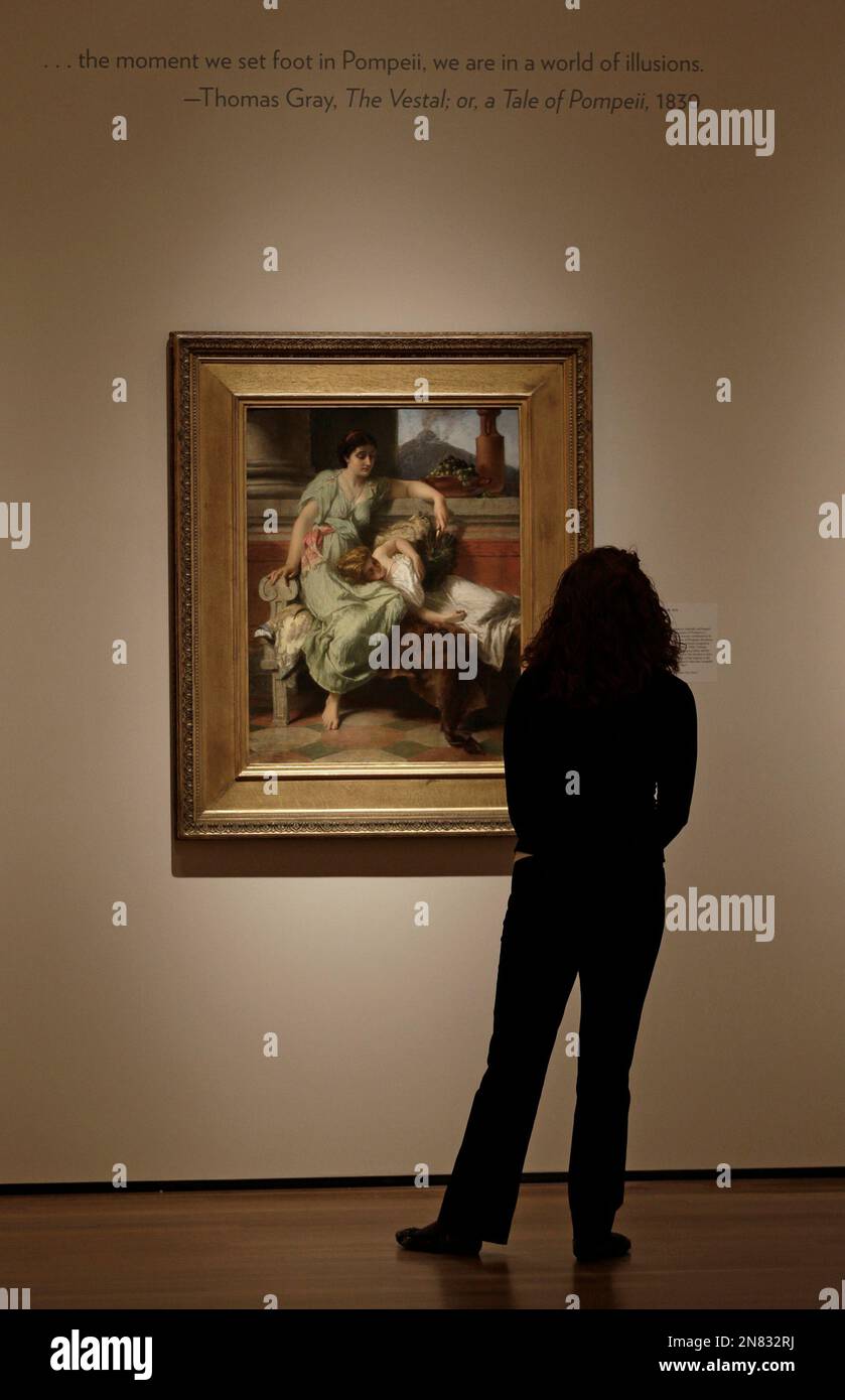 A woman looks at a painting called "Pompeii, AD 79" by Alfred Elmore painted in 1878 during an exhibition called "The Last Days of Pompeii: Decadence, Apocalypse, Resurrection" at The Cleveland Museum of Art Friday, Feb. 22, 2013, in Cleveland. The exhibition will be on view from Feb. 24 through July 7, 2013. (AP Photo/Tony Dejak) Foto Stock