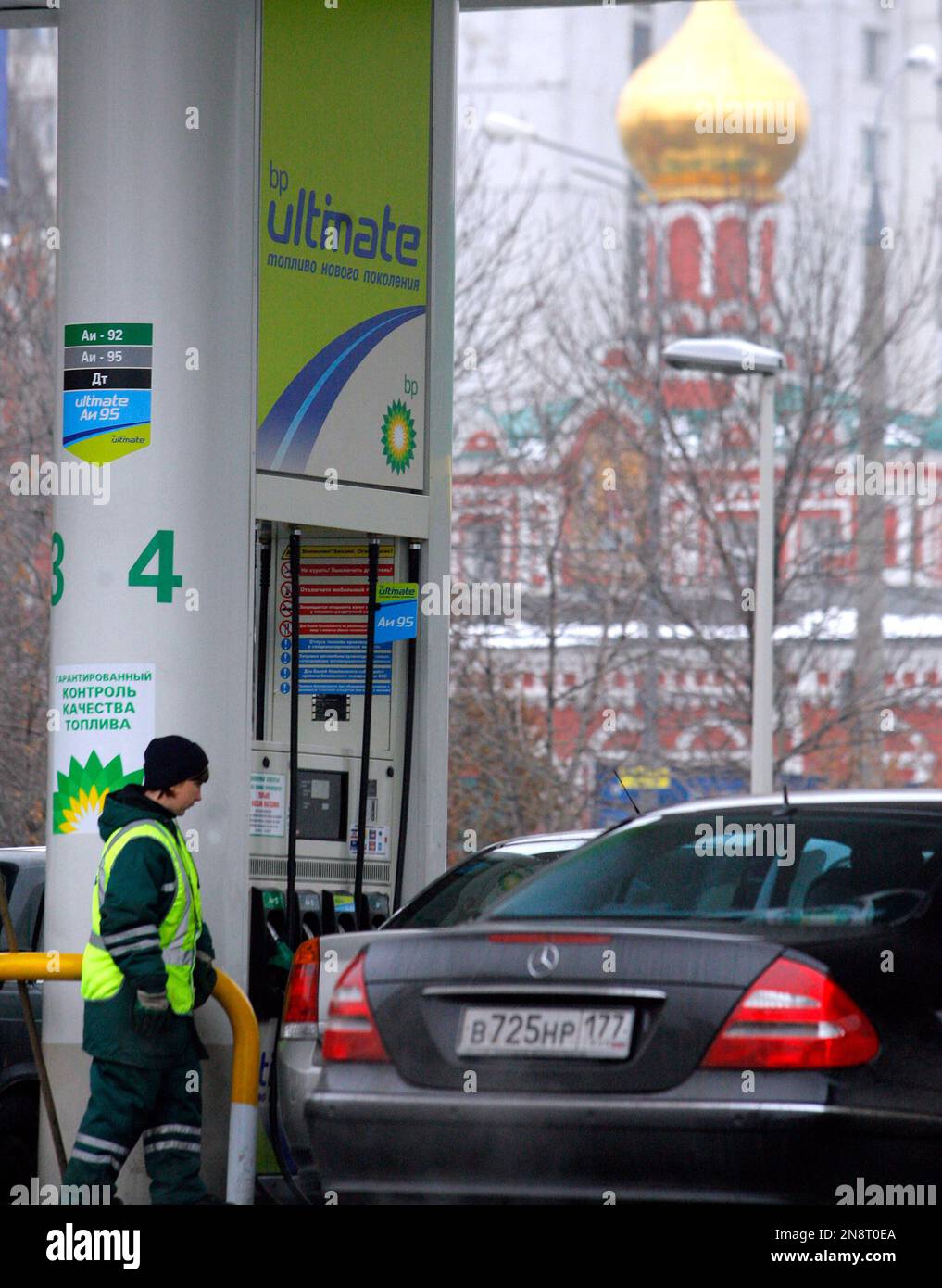 FILE - An employee of a BP gasoline station attends to a customer in ...
