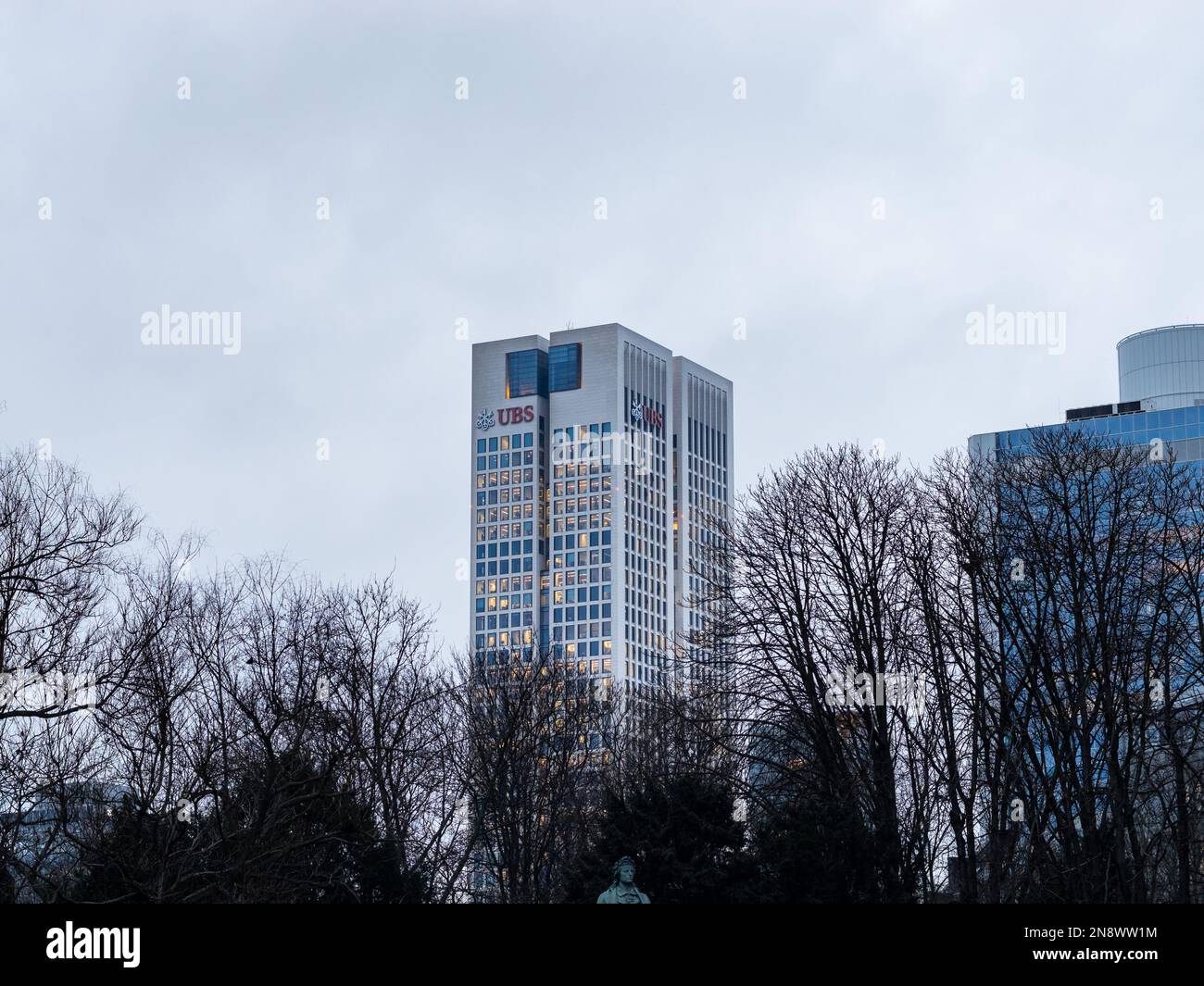 UBS Tower nel distretto bancario. Esterno della banca d'investimento svizzera con il logo sulla parete. Alta architettura di fronte al cielo scuro. Foto Stock