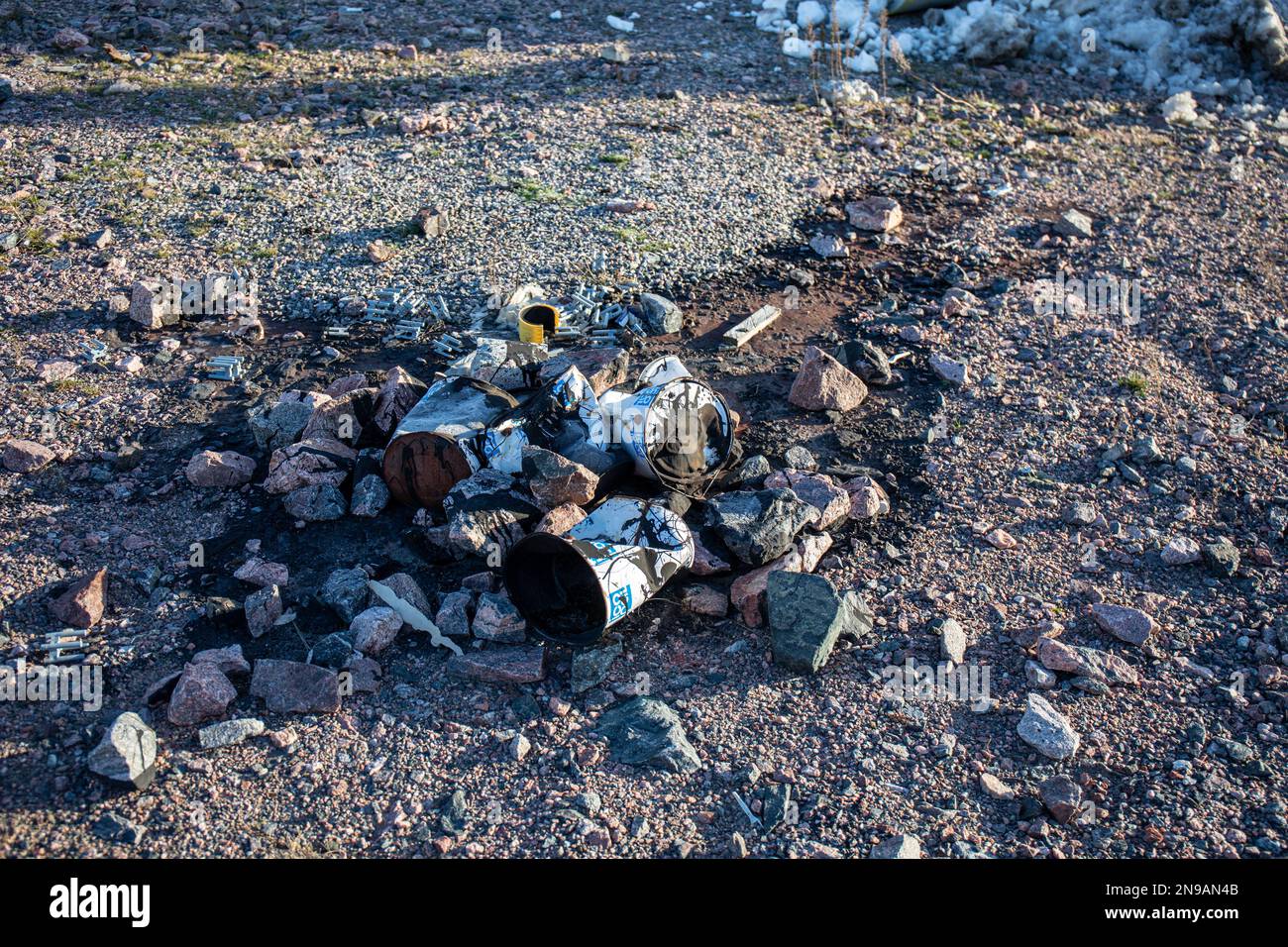 Lattine di primer bituminoso schiacciate con bitume versato sul terreno nel distretto di Jätkäsaari o Länsisatama di Helsinki, Finlandia Foto Stock