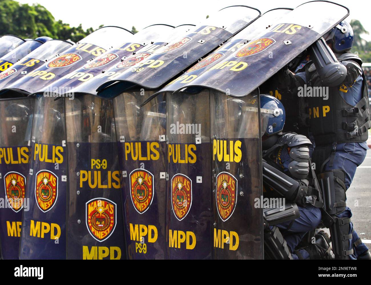 Anti Riot Unit Police Anti-riot police execute an umbrella formation as a protection against ...