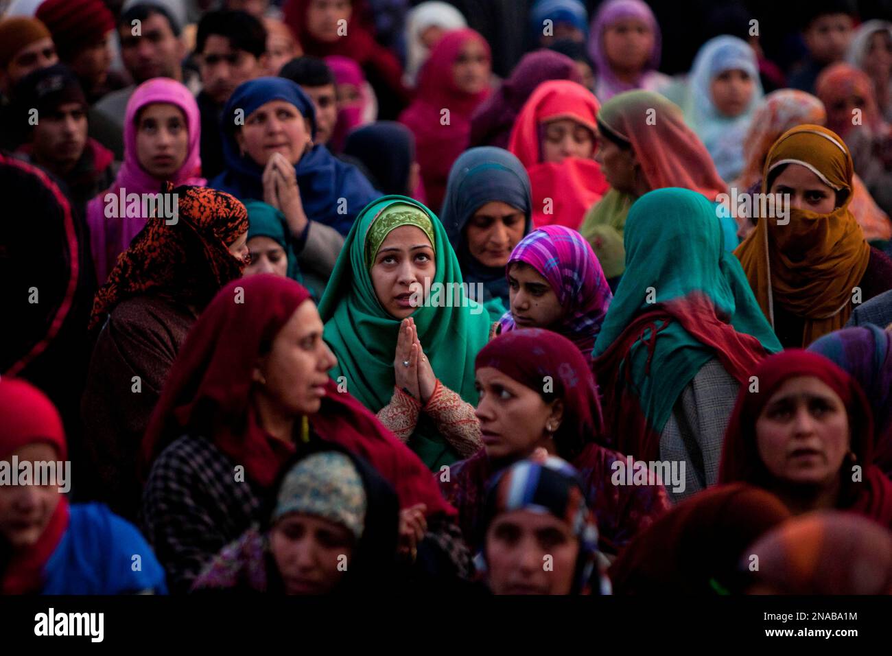 Kashmiri Muslim women pray as the head priest, unseen, displays a relic ...