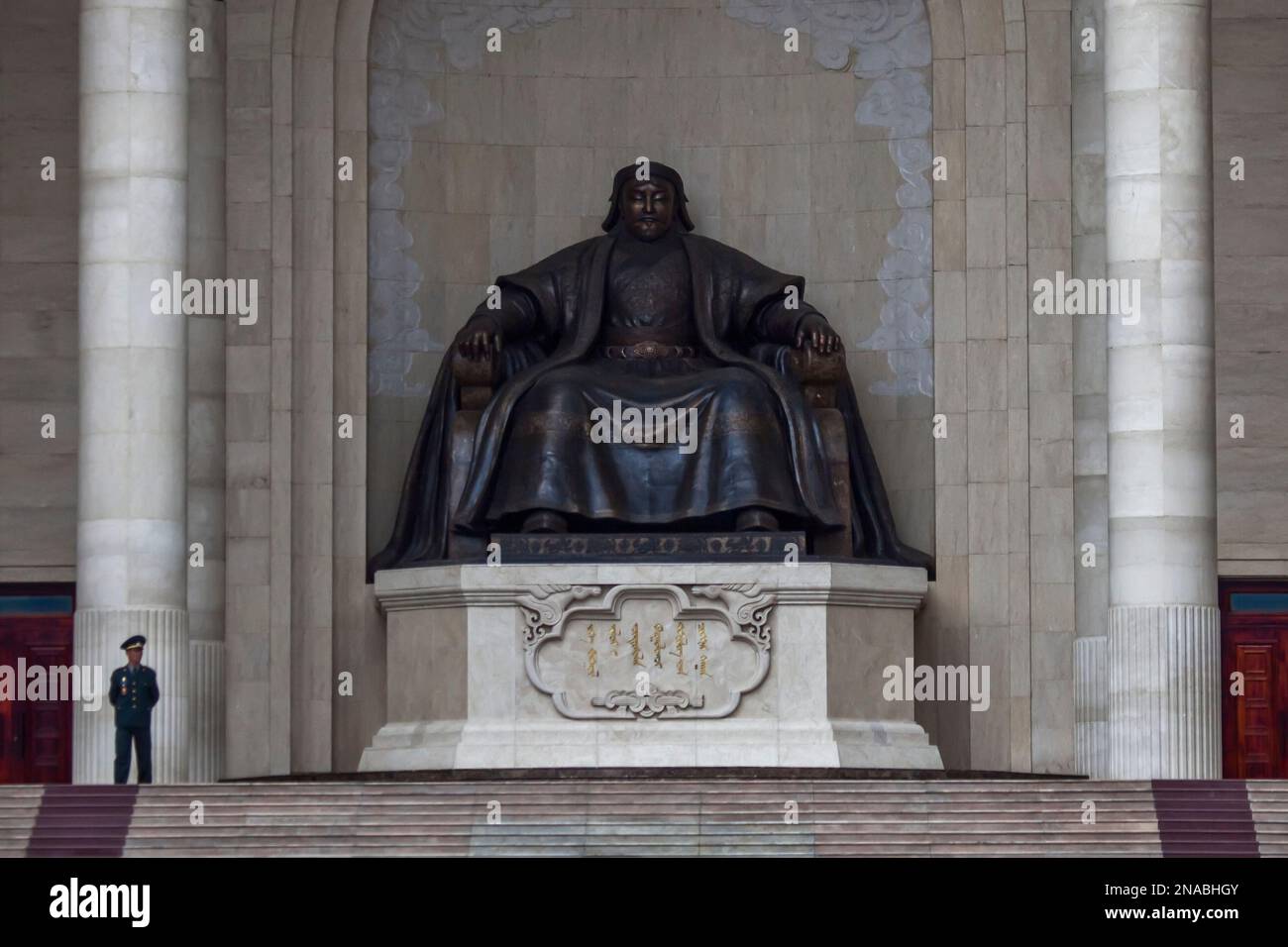 Una guardia sorge accanto a una scultura di Gengis Kahn. Foto Stock