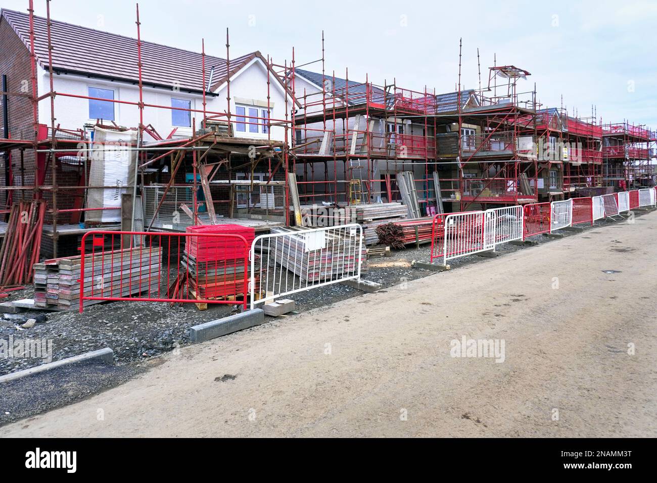 Case moderne in costruzione con ponteggi e barriere di accesso, Troon, Scozia, Regno Unito Foto Stock