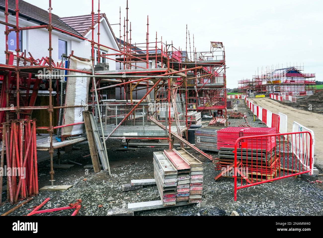 Case moderne in costruzione con ponteggi e barriere di accesso, Troon, Scozia, Regno Unito Foto Stock