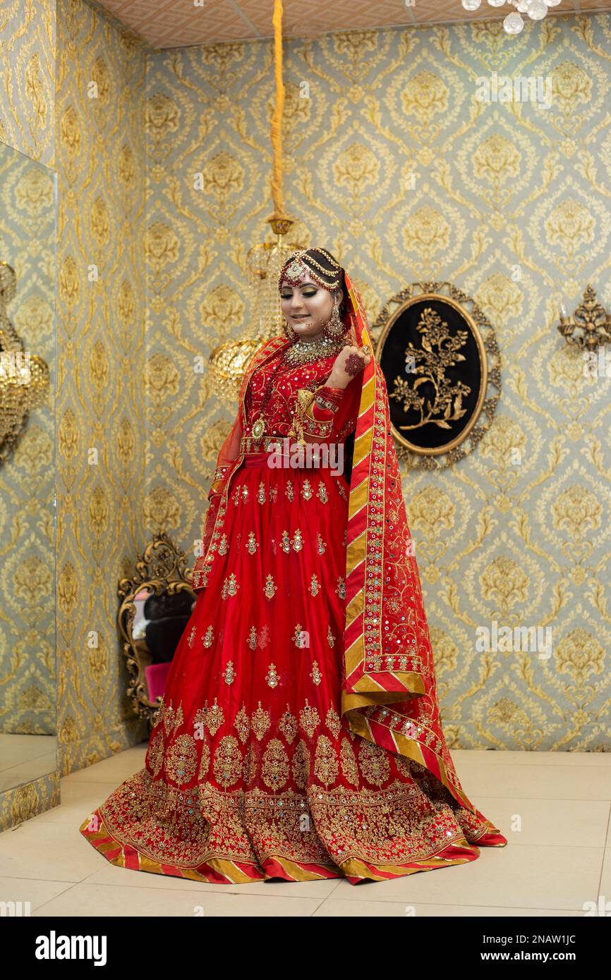 Sposa indiana e pakistana vestita con abiti da sposa tradizionali Foto Stock