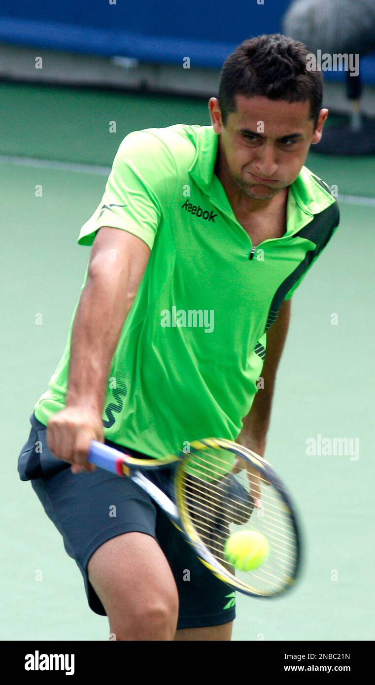 Nicolas Almagro, from Spain, hits a shot from Thomas Berdych, from Czech Republic, during a match at the Western & Southern Open tennis tournament, Thursday, Aug. 18, 2011, in Mason, Ohio. Berdych won 6-2, 6-2. (AP Photo/David Kohl) Foto Stock