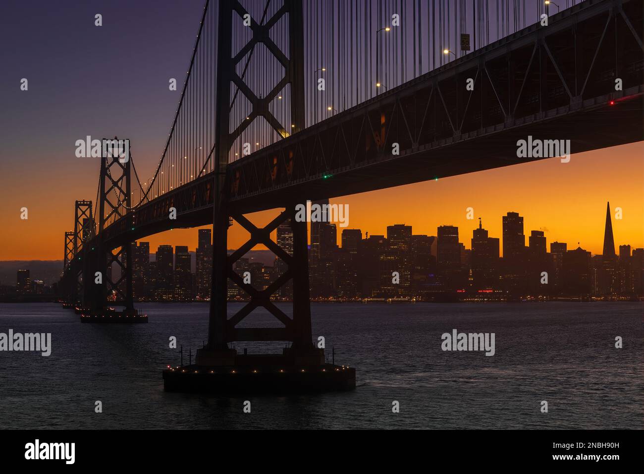 Il Bay Bridge e il lungomare di San Francisco durante la Blue Hour Foto Stock