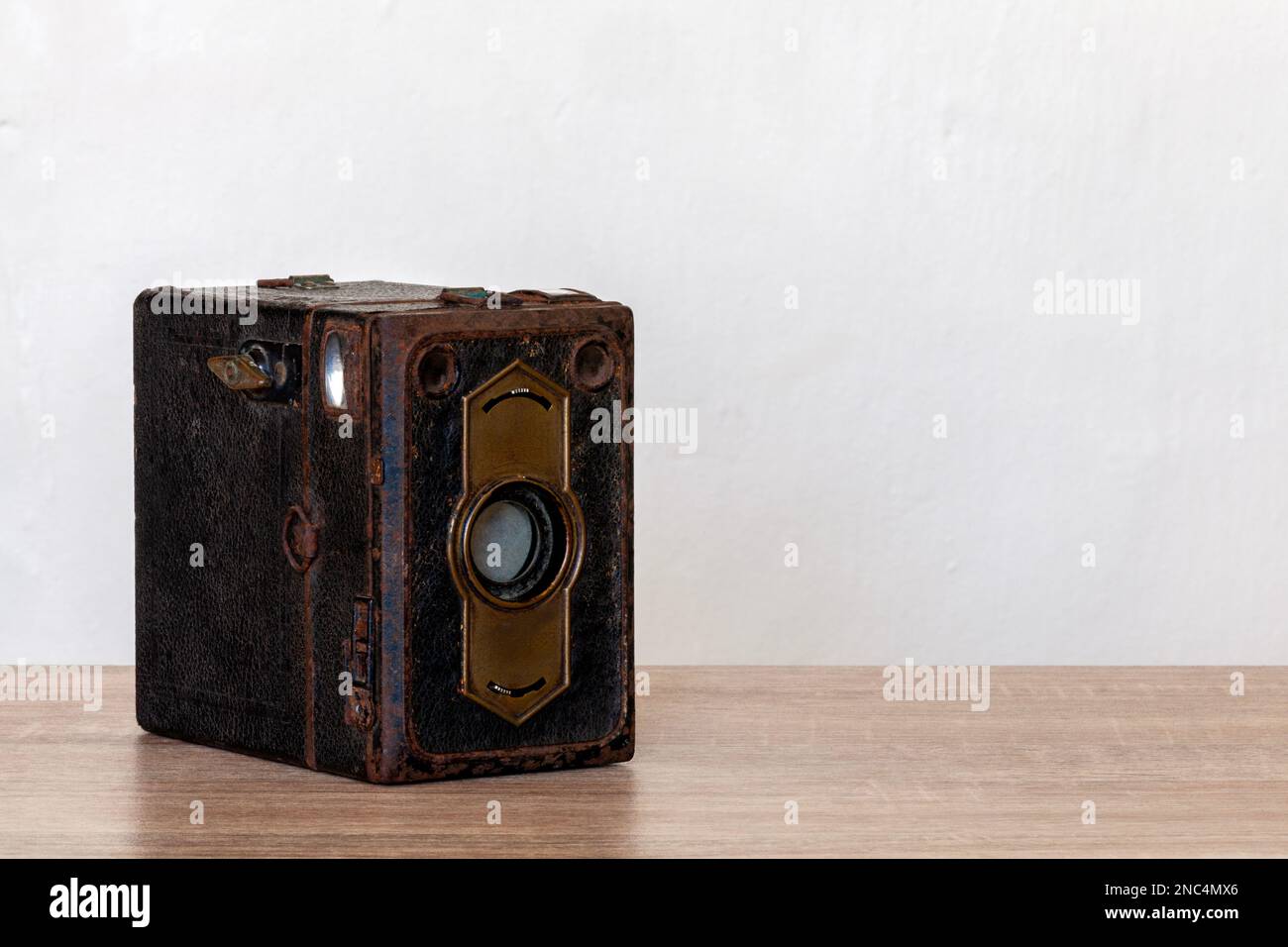 Fotocamera classica con pellicola su una scrivania in legno e spazio per le copie. Foto Stock