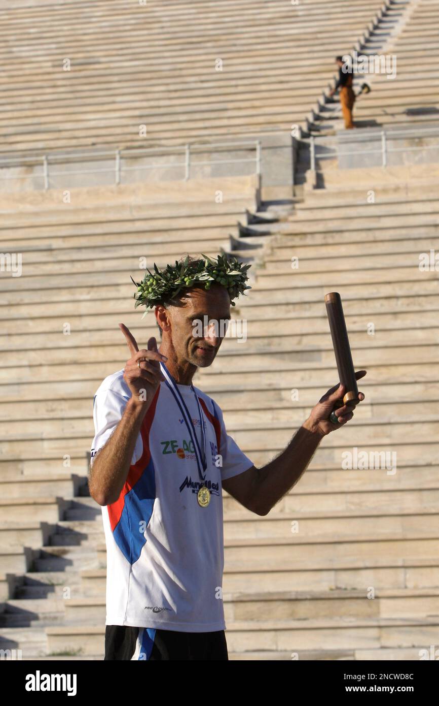 german-ultramarathon-runner-jurgen-mennel-wears-an-olive-wreath-after