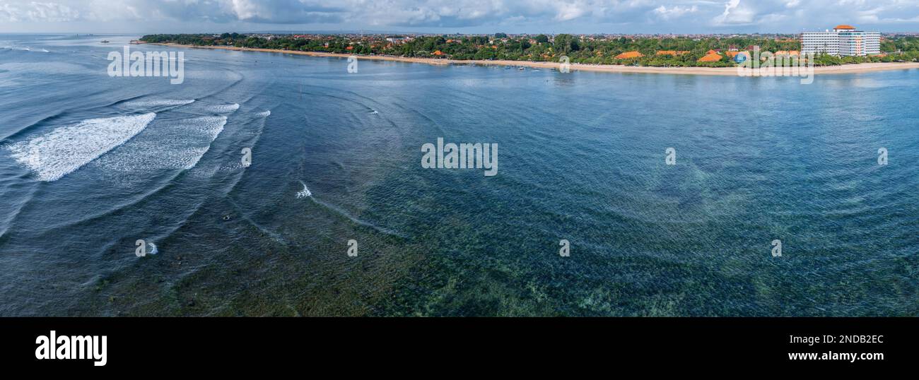 Vista panoramica aerea su un'ampia spiaggia molto bassa e tranquilla con molta erba di mare, spiaggia di Sanur, Bali, Indonesia Foto Stock