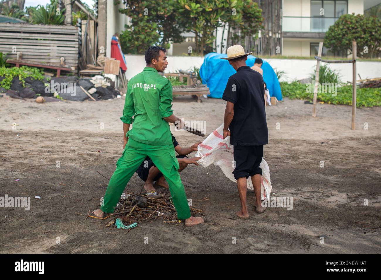 Bali, Indonesia - 15 febbraio 2023: Uomini non identificati che puliscono la spiaggia a Bali, Indonesia. Foto Stock