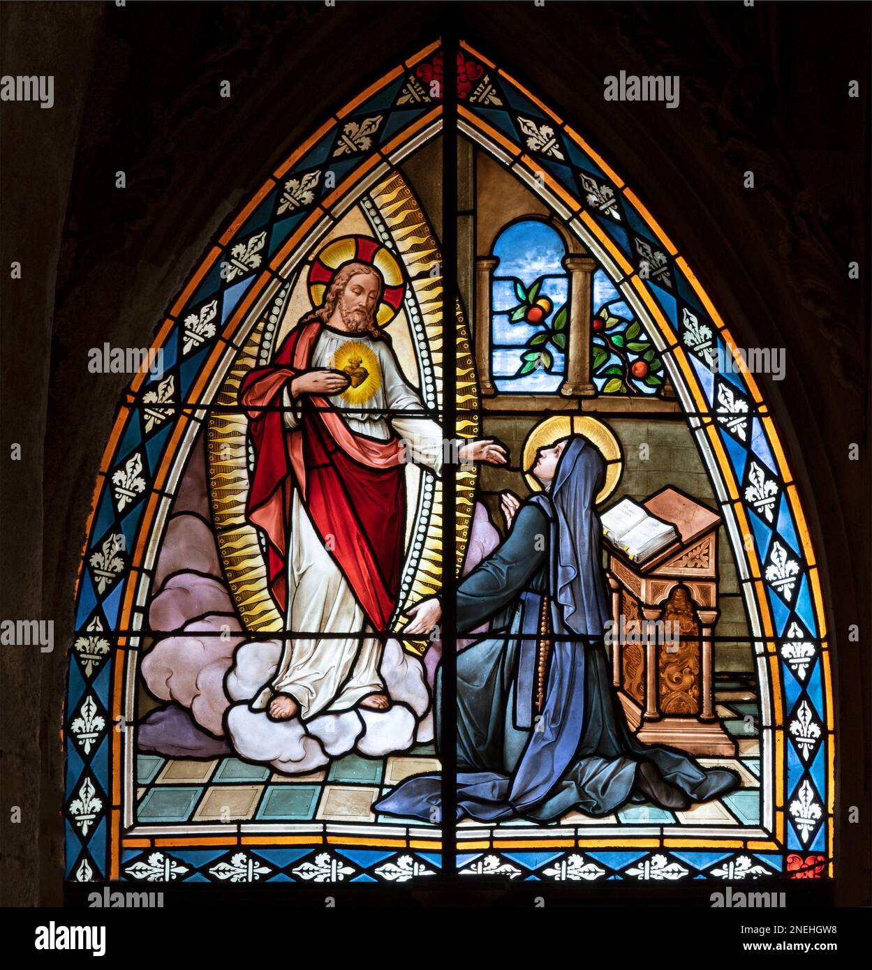BIELLA, ITALIA - 15 LUGLIO 2022: L'apparizione del cuore di Gesù a S. Teresa di Avila nella vetrata del Duomo dal 19. cent. Foto Stock
