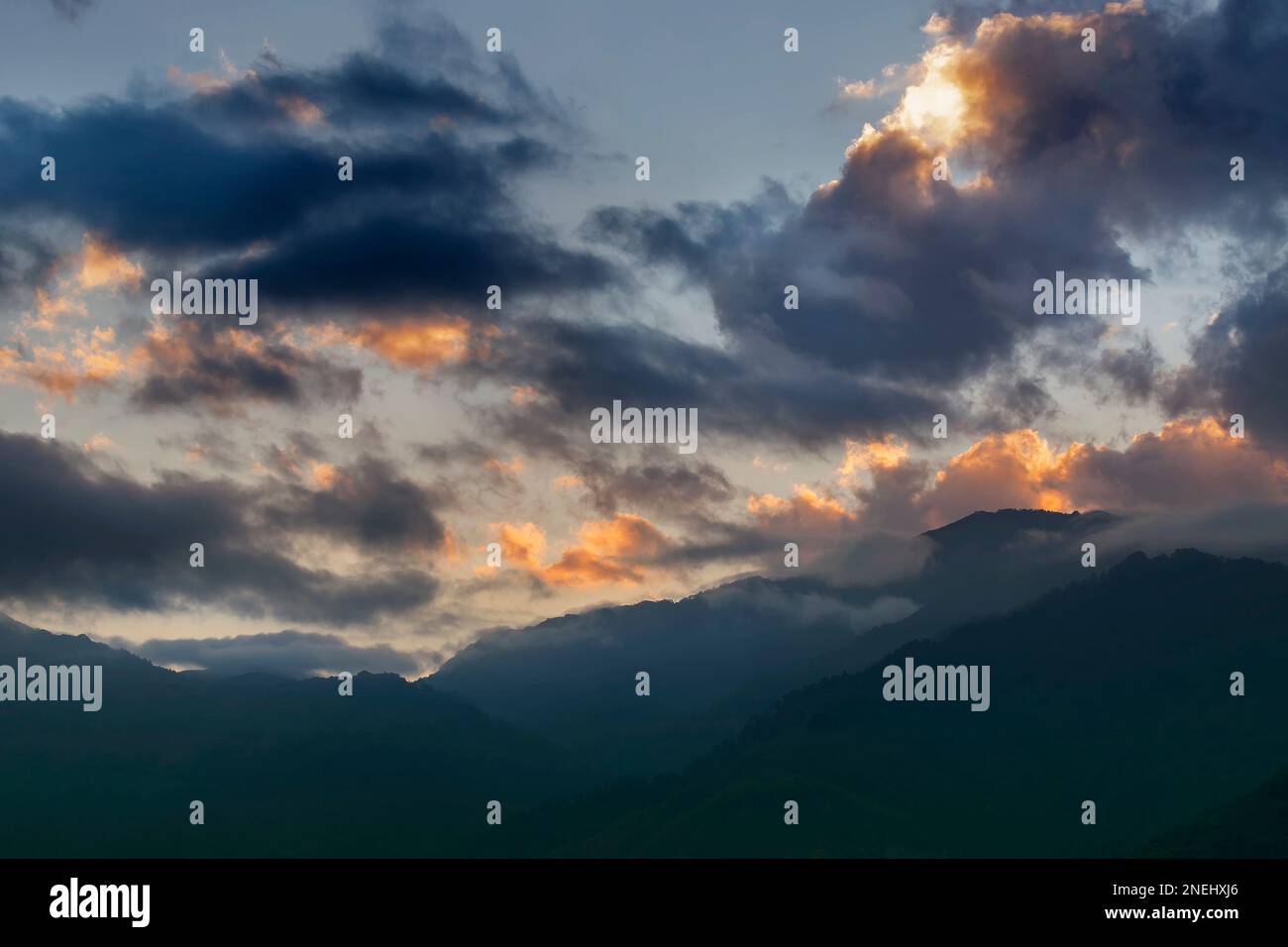 Nuvole colorate sopra la catena montuosa dell'Himalaya dopo che il sole è tramontato oltre le cime delle montagne. Dopo il sole tramonta l'immagine di riserva della natura , ripresa a Okhrey, Sikkim Foto Stock
