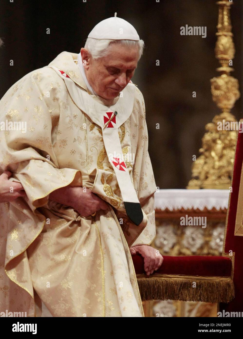 Pope Benedict XVI is assisted as he arrives to celebrate Christmas Mass ...