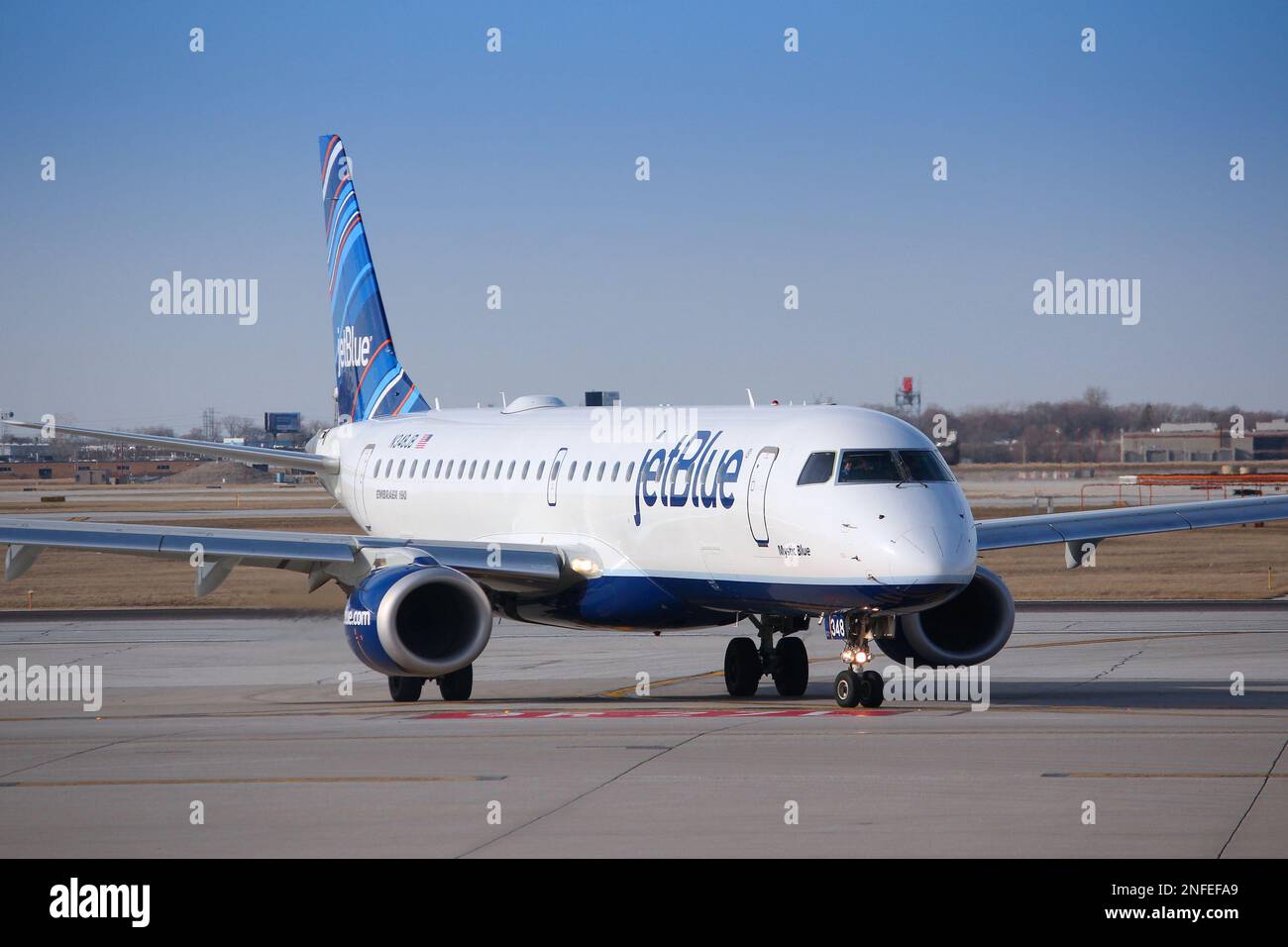 CHICAGO, STATI UNITI - 1 Aprile 2014: Jetblue Embraer taxi dopo l'atterraggio all'Aeroporto O'Hare di Chicago. JetBlue è un americano di compagnia aerea low-cost wit Foto Stock