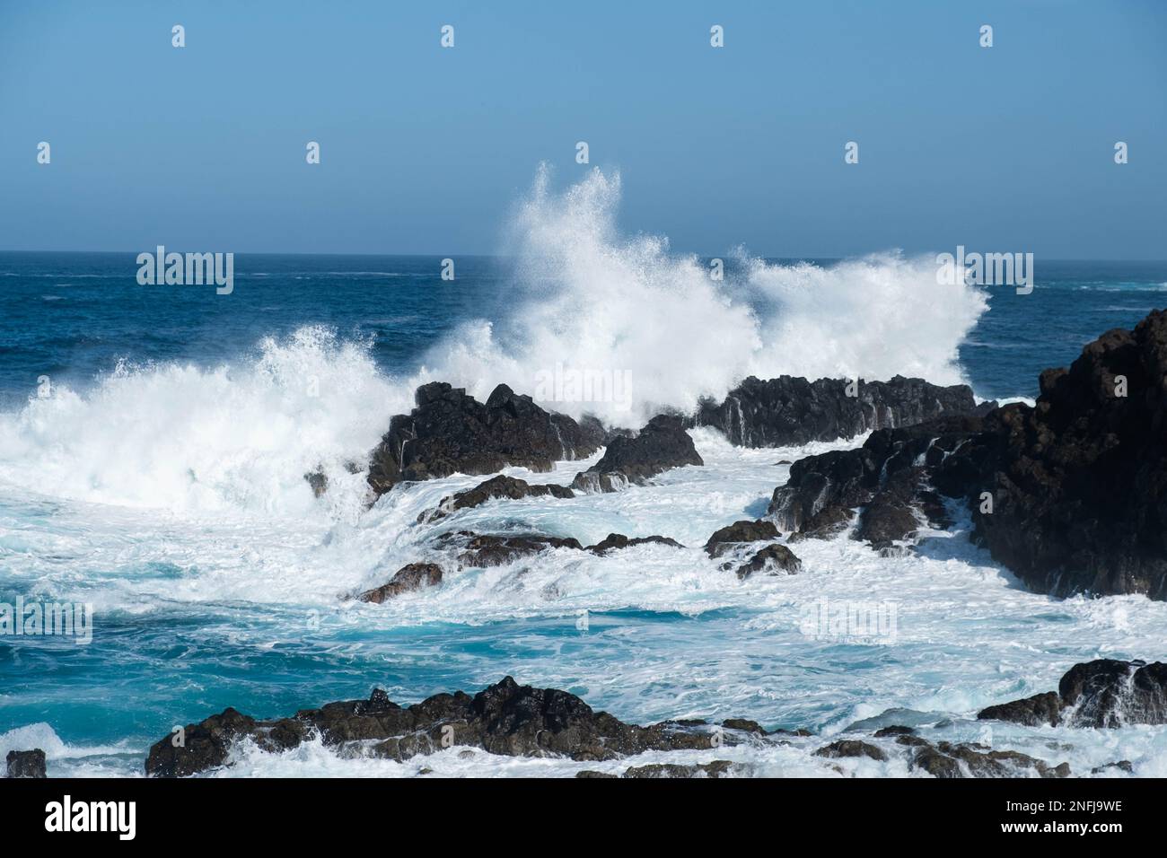 le onde dell'oceano si schiantano sulle rocce, il tempo ventoso Foto Stock