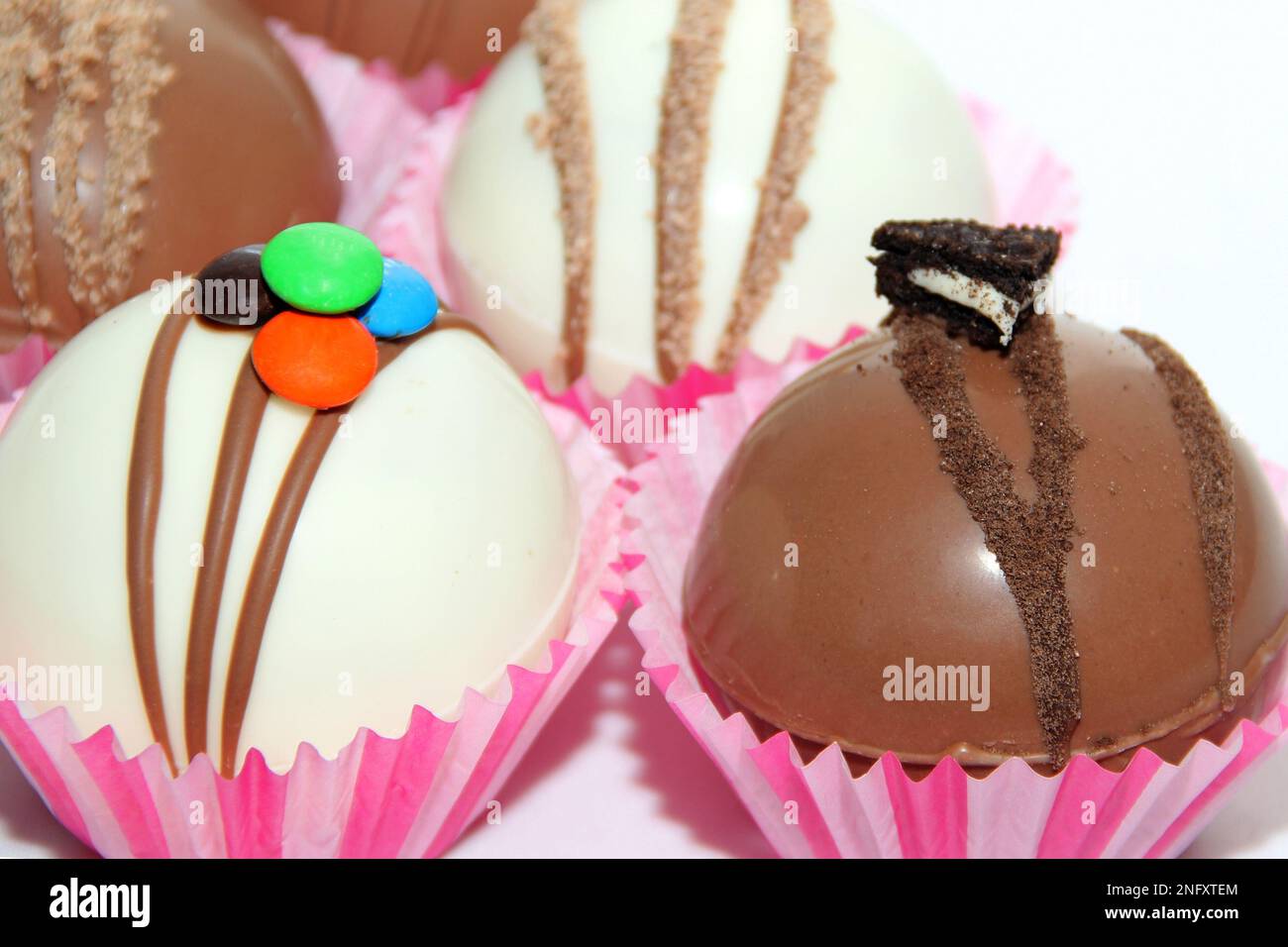 Set di bombe al cioccolato, ripieno di marshmallow e cioccolato bianco su sfondo bianco Foto Stock