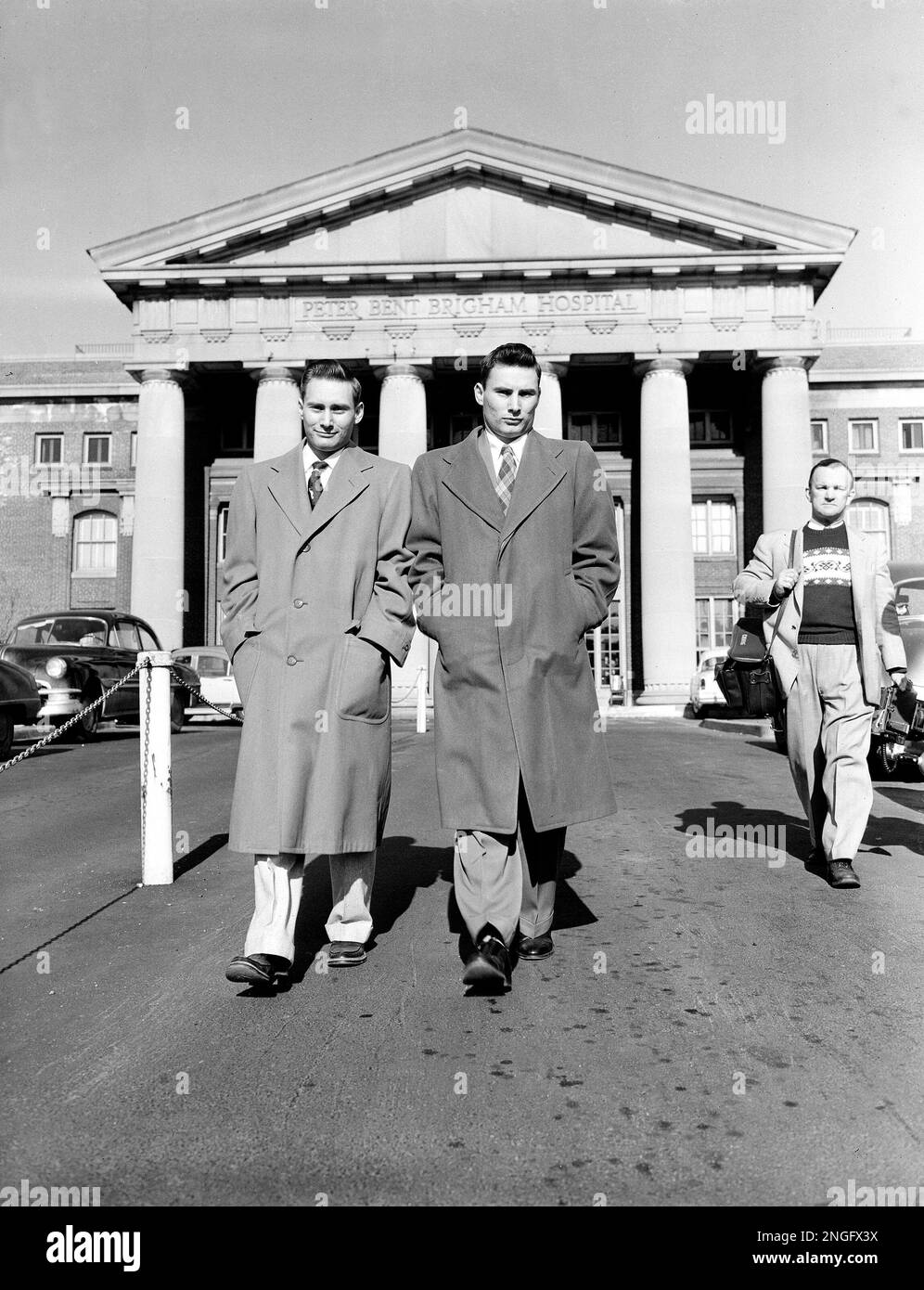 Richard Herrick, left, and his twin brother, Ronald, leave Peter Bent Brigham Hospital in Boston, Ma., on Jan. 30, 1955, after fully recovering from a kidney transplant, Dec. 23, a first between identical twins. Ronald donated one of his kidneys to his 23-year-old brother Richard, who suffered from uremic poisoning because of chronic kidney failure. Richard now has three kidneys, and surgery may later remove his original two. (AP Photo) Foto Stock