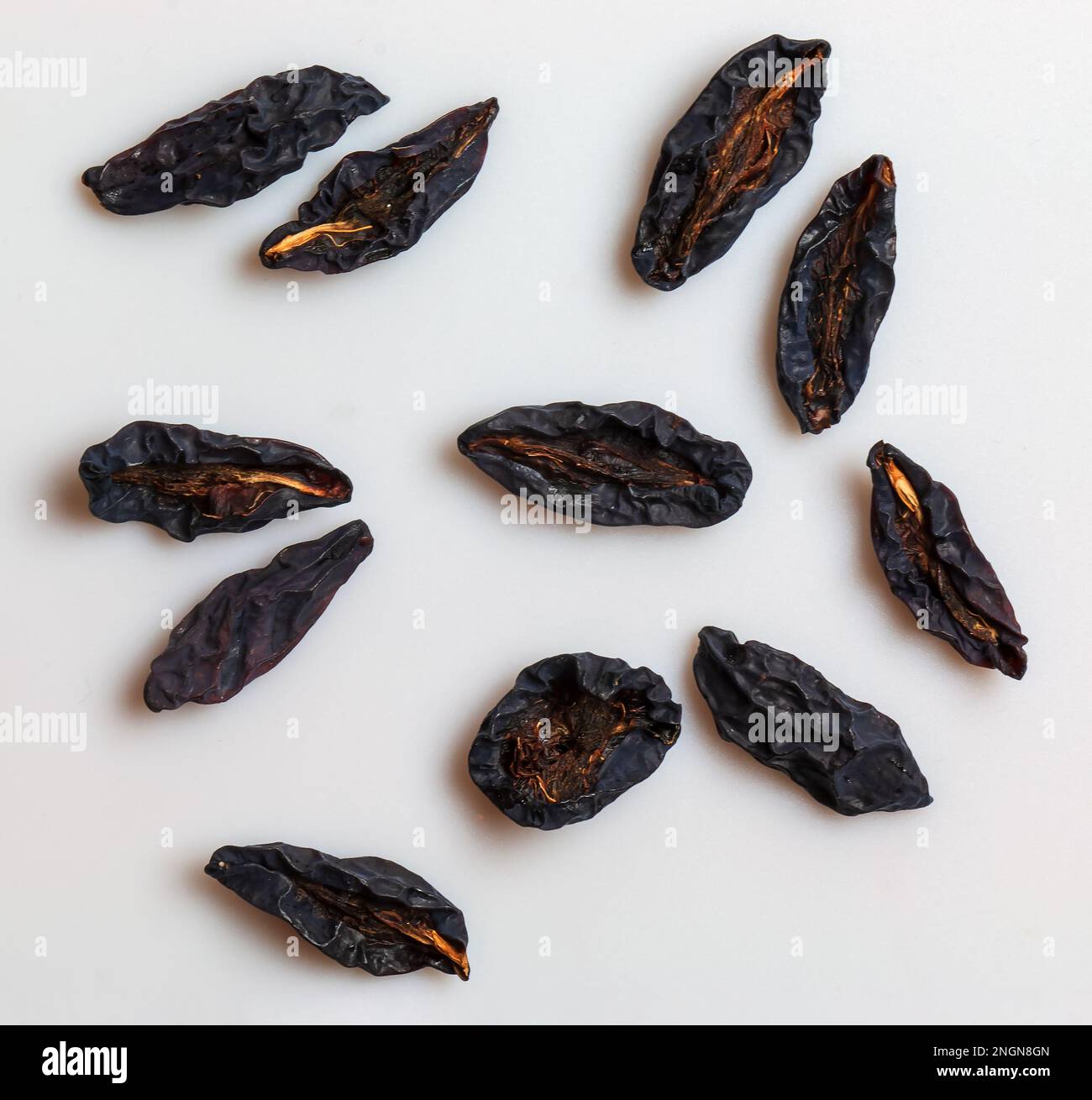 Prugne secche o prugne su fondo bianco. Vista dall'alto. Giacitura piatta Foto Stock
