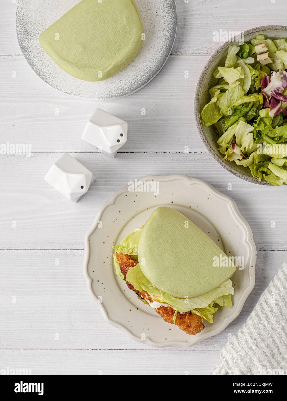 il panino è verde, al vapore, con foglie di verdure e semi di sesamo Foto Stock