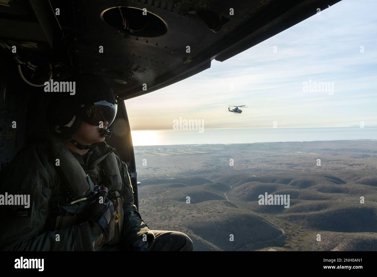 STATI UNITI Ryan Wolfe, un capo dell'equipaggio di Venom UH-1Y con Marine Light Attack Helicopter Squadron 169, Marine Aircraft Group 39, 3rd Marine Aircraft Wing (MAW), osserva l'area mentre vola in una Venom UH-1Y durante Exercise Steel Knight 23, su Camp Pendleton, California, 3 dicembre 2022. Exercise Steel Knight 23 fornisce a 3rd MAW l'opportunità di perfezionare la lotta di livello Wing a supporto di MEF i e la manovra della flotta. Wolfe è un nativo di New Braunfels, Texas. Foto Stock