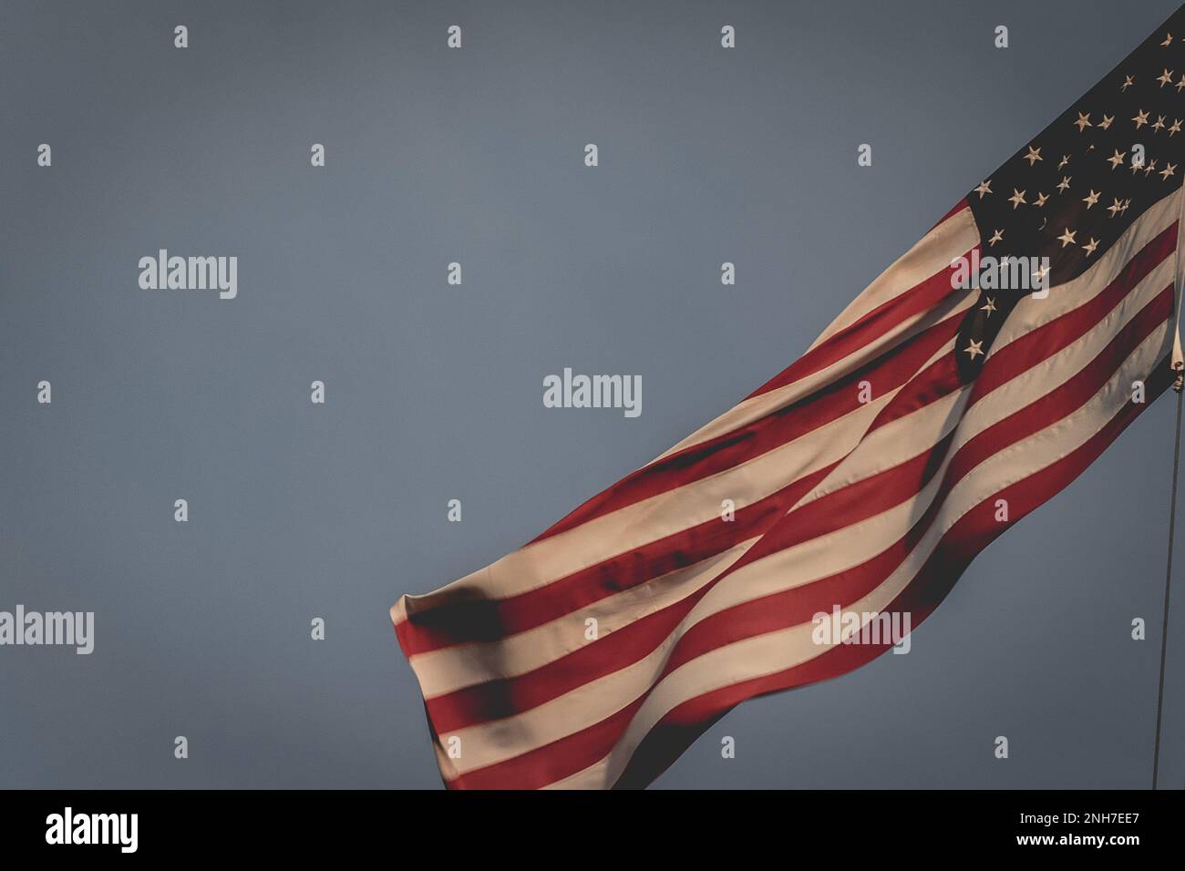 Bandiera americana che sventola al vento, al cimitero americano di Magraten, nei Paesi Bassi. Foto Stock