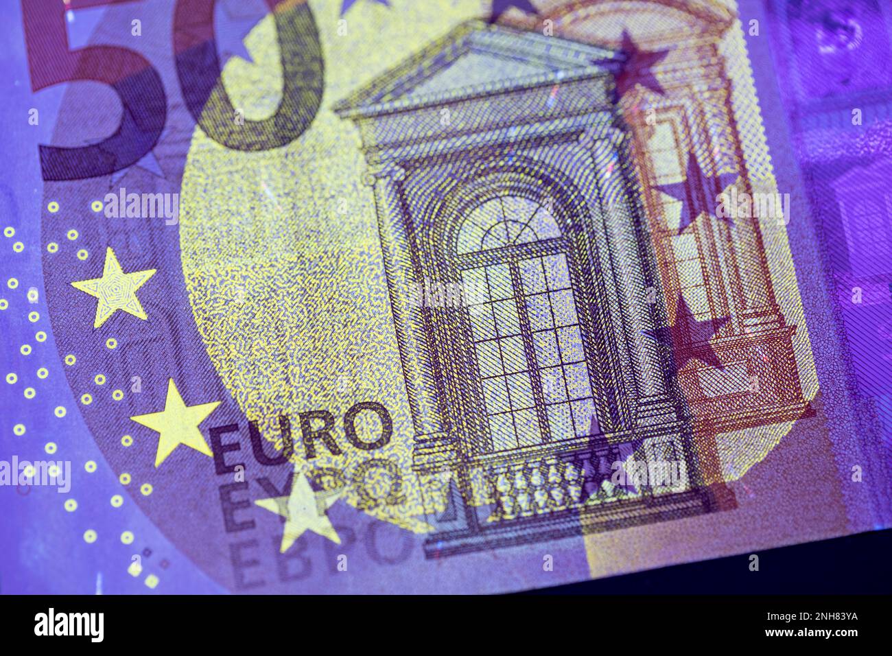 Valuta europea in protezione dalla luce UV. Euro in luce UV per controllare l'autenticità del denaro. Foto Stock