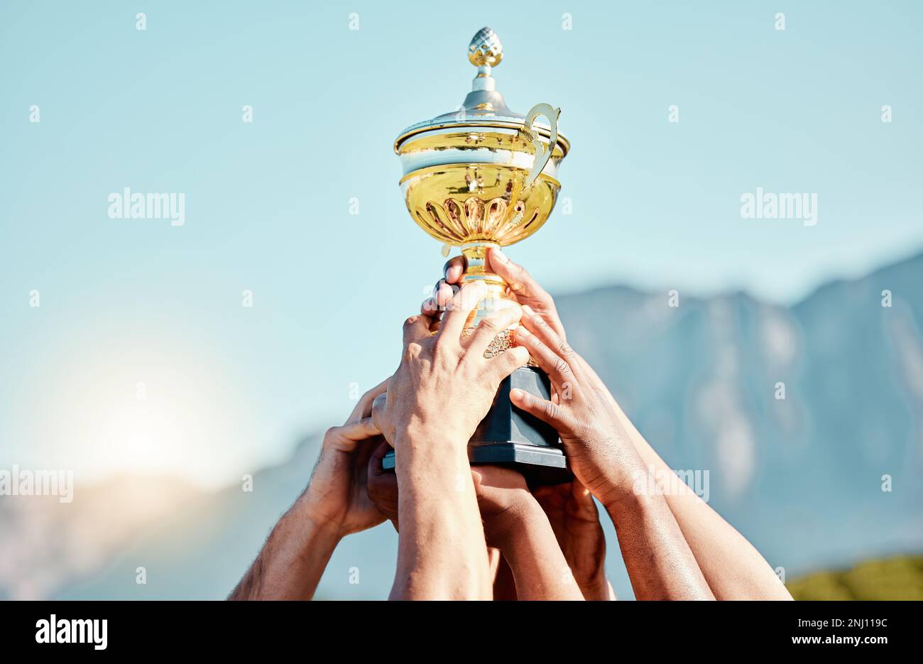 Sport, campione e mani di squadra con trofeo per il raggiungimento, l'obiettivo e il successo insieme. Festeggiamenti, vincitori e persone che tengono una coppa di premiazione dopo Foto Stock