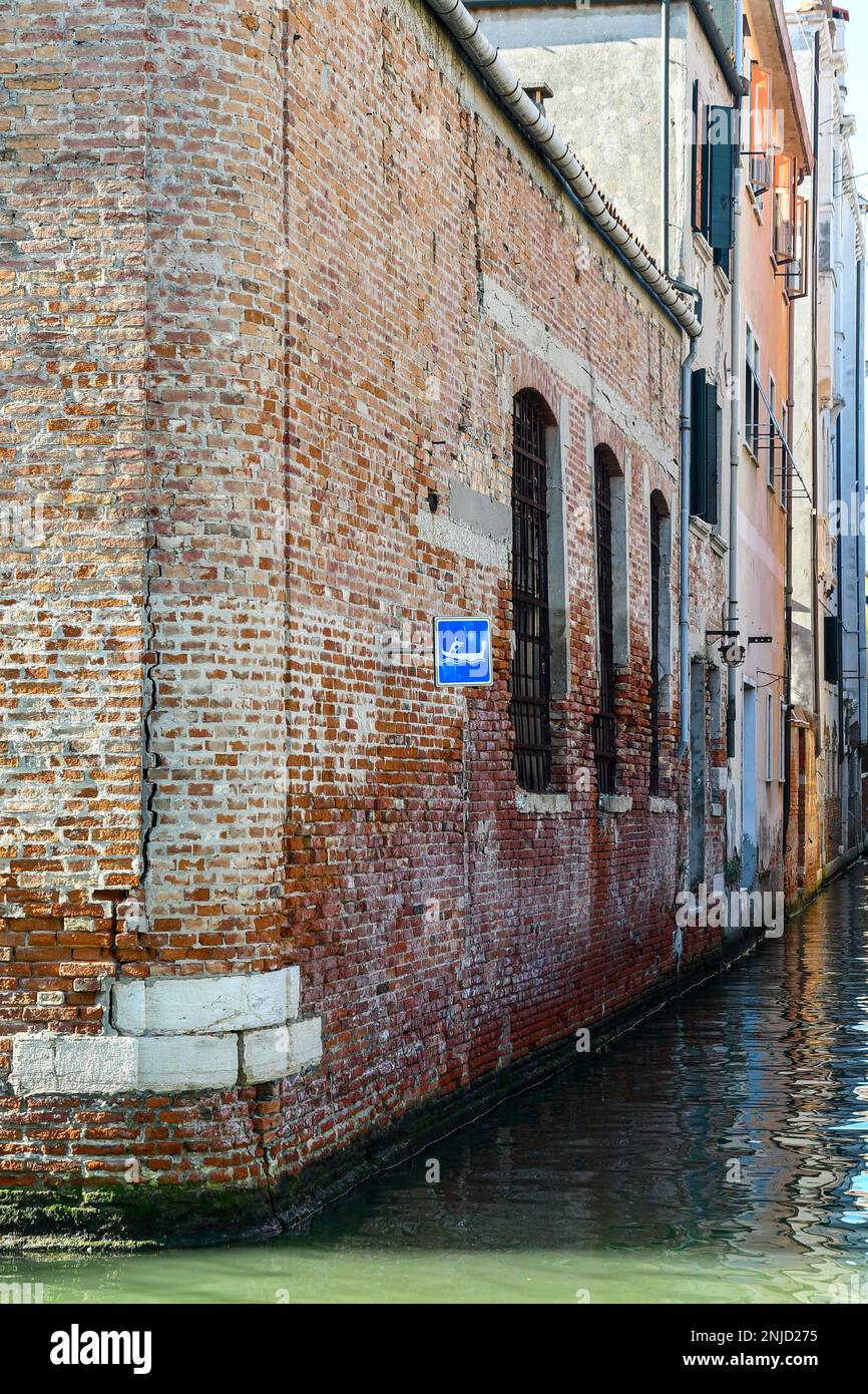 Cartello indicante il passaggio delle gondole sulla parete di un edificio in mattoni che si affaccia sul canale del Rio Lustraferi, Cannaregio sestiere, Venezia, Italia Foto Stock