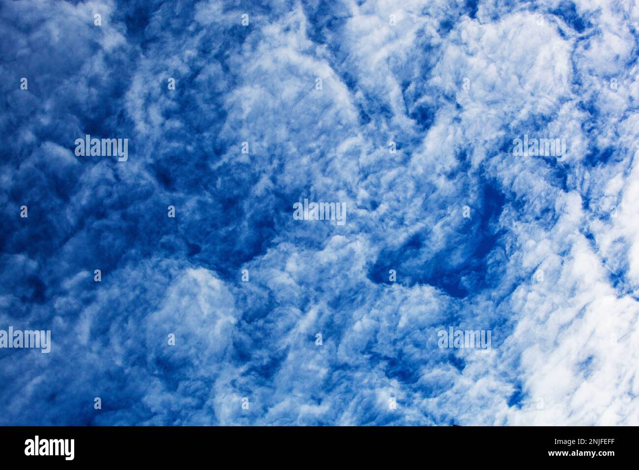 Le nuvole di cumulonimbus formano un bel motivo contro un cielo blu Foto Stock