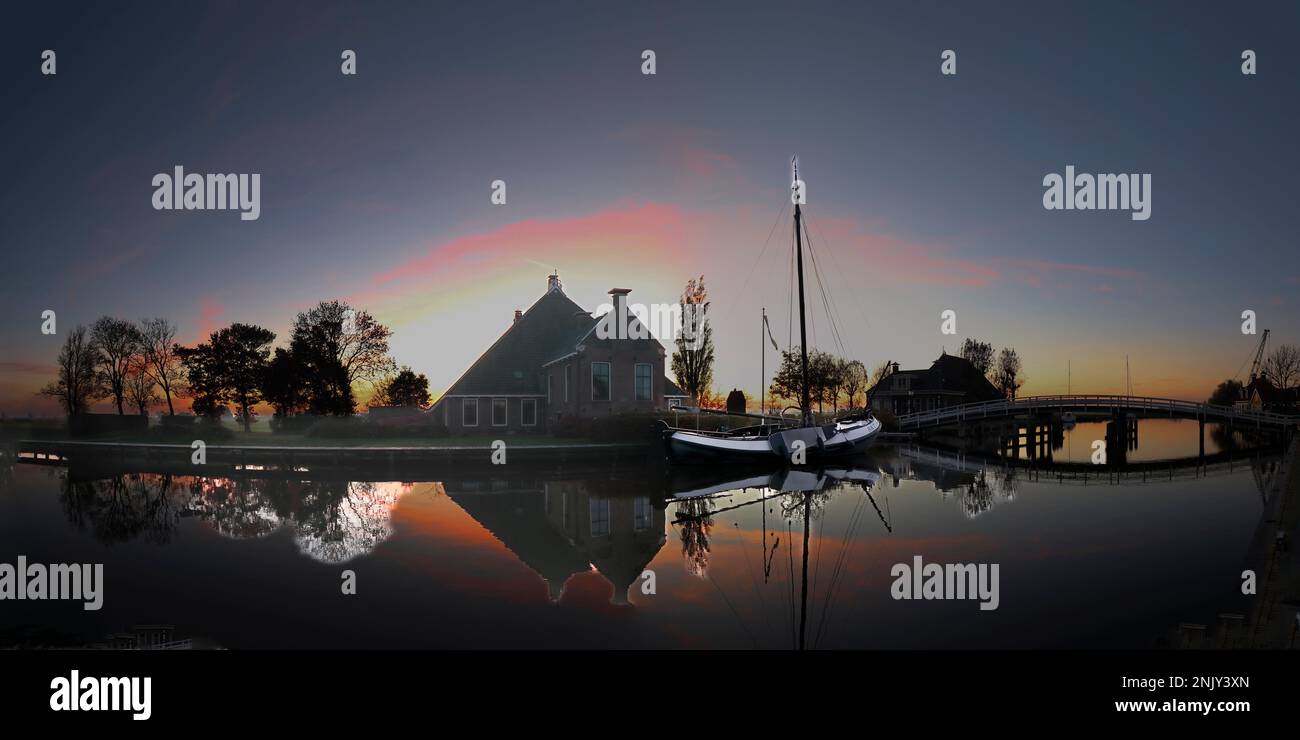 Agriturismo e nave a fondo piatto dopo il tramonto, Paesi Bassi, Frisia Foto Stock