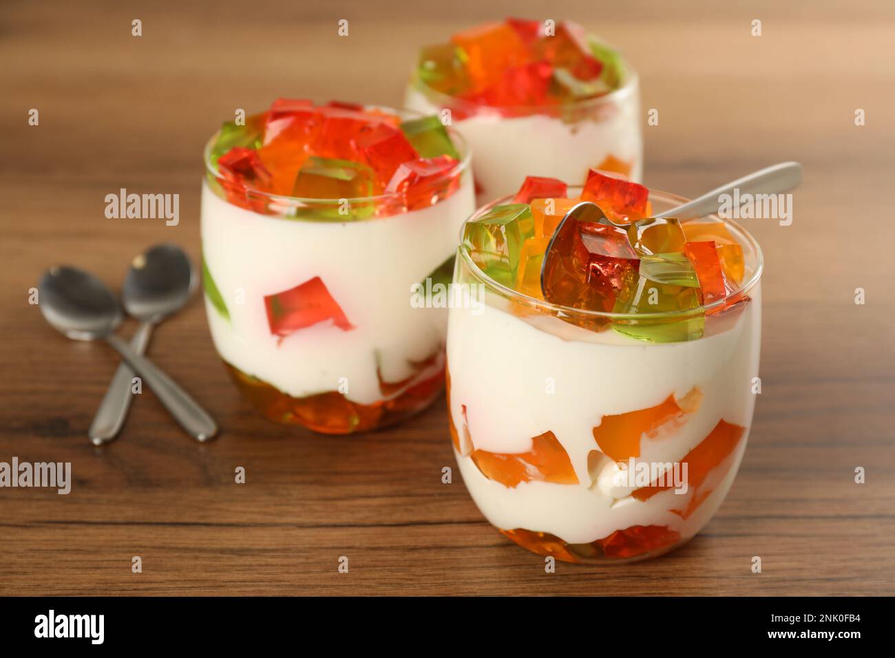 Delizioso dessert di gelatina di vetro spezzato su un tavolo di legno Foto Stock