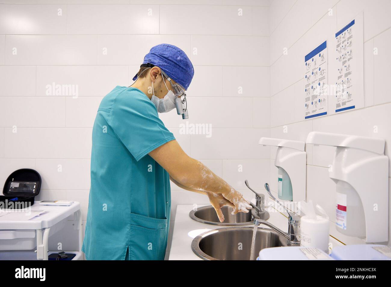 Il chirurgo lavando le mani nel lavandino all'ospedale Foto Stock