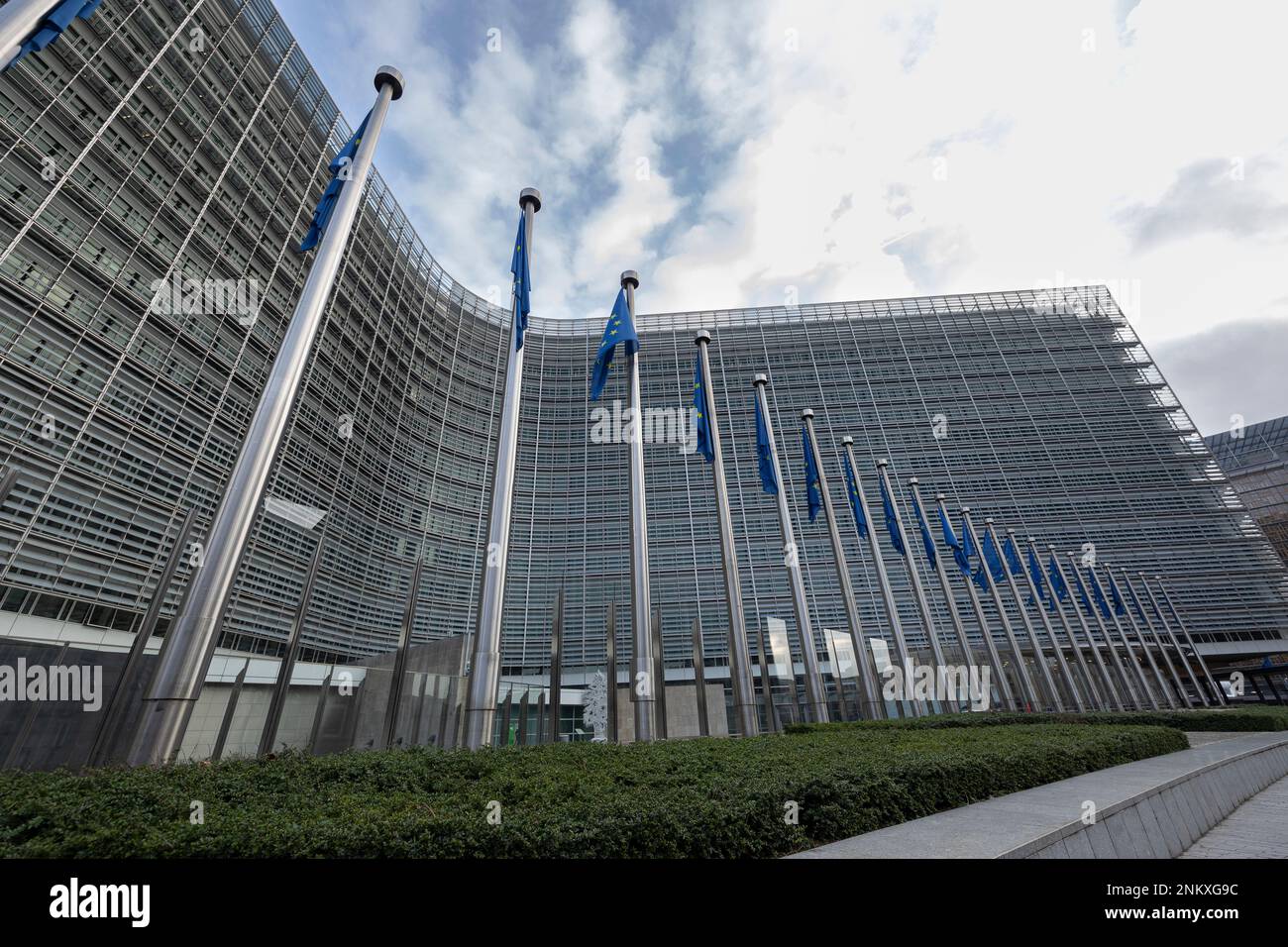 BRUXELLES, Belgio - 23 febbraio 2023: Edificio Berlaymont, sede della Commissione europea, con bandiere che soffiano nel vento davanti ad esso Foto Stock