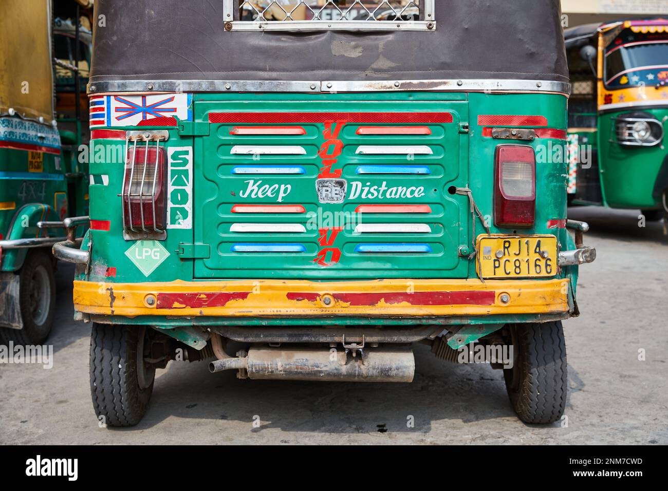 Primo piano colorato dipinto a mano sul retro di un tuc-tuc nel Rajasthan Foto Stock