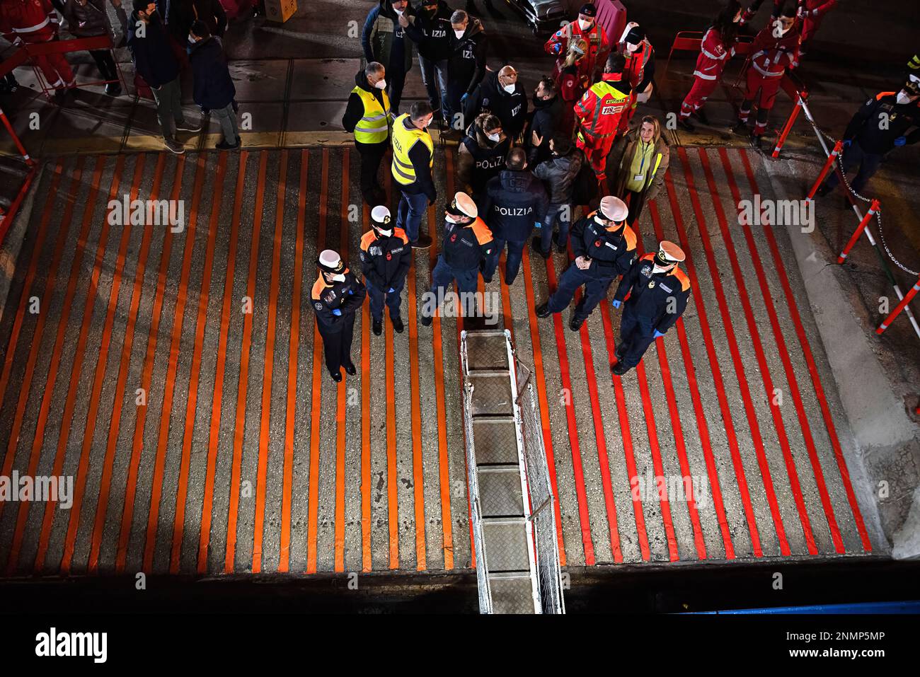 Ortona, Italia. 25th Feb, 2023. Guardia Costiera e poliziotti aspettano di firmare in salvo i migranti che sbarcano al porto di Ortona. Dopo 4 giorni di traversata per il porto di Ortona in Italia, i 40 migranti sub-sahariani salvati a 44 miglia e mezzo da Lampedusa sono sbarcati in un porto sicuro e sono nelle mani delle autorità di polizia italiane. Credit: SOPA Images Limited/Alamy Live News Foto Stock