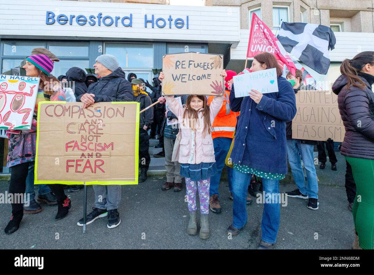 Gli anti-fascisti provenienti da Cornwall resistono, si trovano davanti al Beresford Hotel a Newquay, in Cornovaglia, che ospita i rifugiati, mentre i manifestanti del gruppo di estrema destra Patriotic alternative montano la propria protesta di fronte. Data immagine: Sabato 25 febbraio 2023. Foto Stock