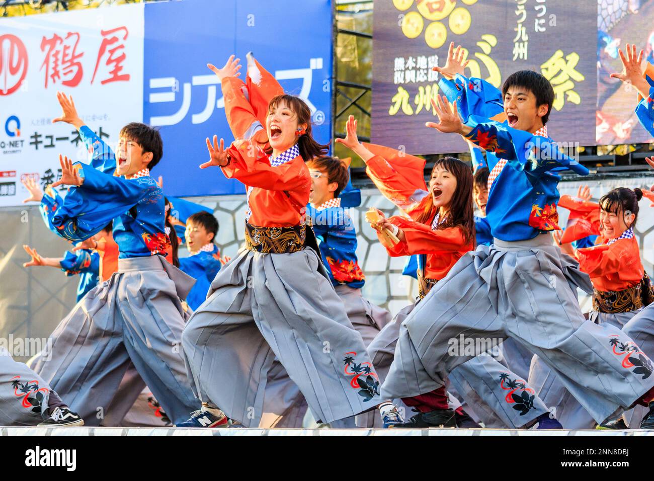 Squadra giapponese di giovani ballerini Yosakoi che ballano in yukata tunica a maniche lunghe sul palco all'aperto al festival annuale Kyusyu Gassai a Kumamoto. Foto Stock