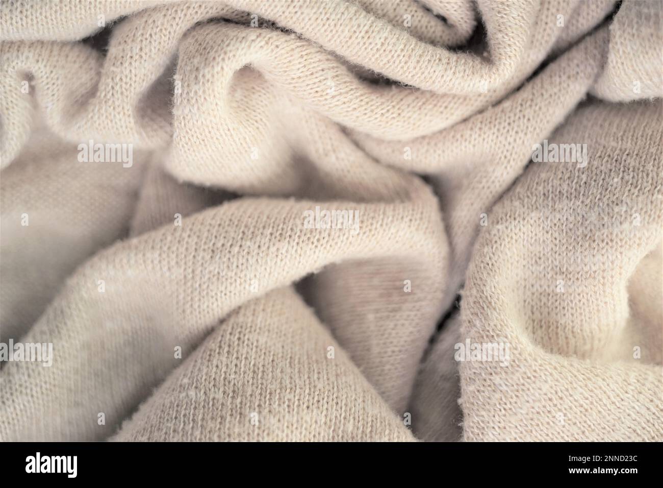 Fondo in maglia cremosa, motivo morbido beige maglione. Foto Stock