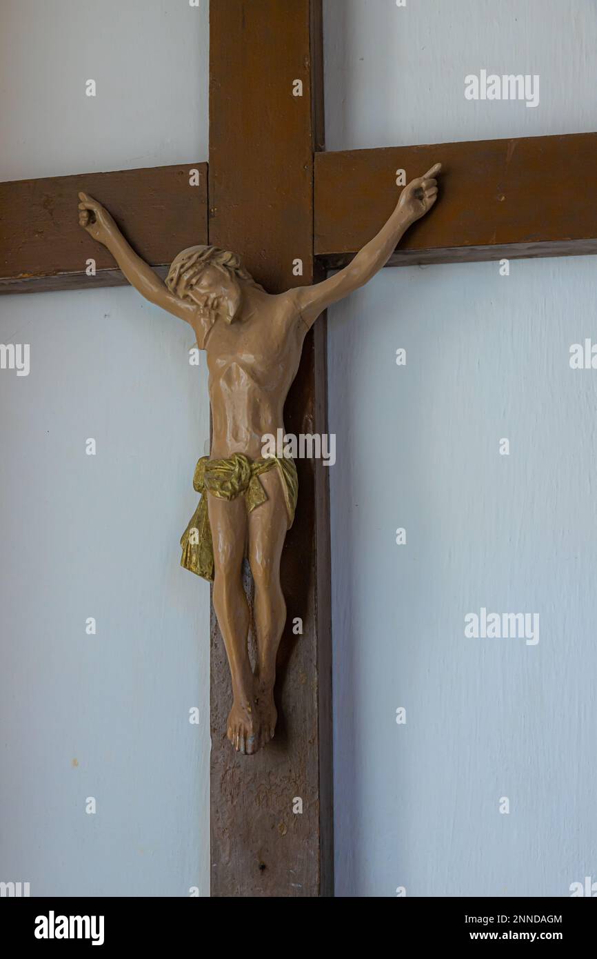 Gesù cristo sulla croce con sfondo muro nella chiesa cattolica. Foto Stock