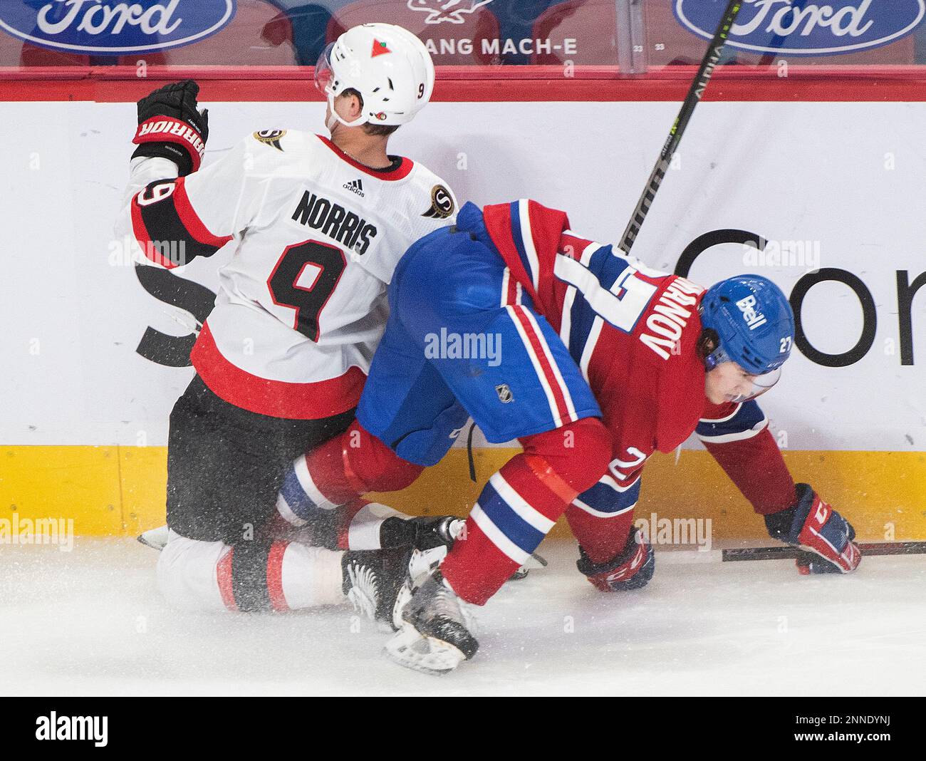 Montreal Canadiens' Alexander Romanov (27) collides with Ottawa Senators Josh Norris during the second period of an NHL hockey game in Montreal, Saturday, May 1, 2021. (Graham Hughes/The Canadian Press via AP) Foto Stock