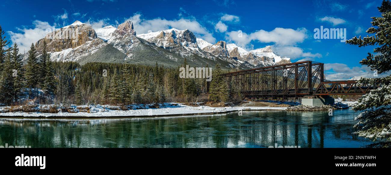 Ponte ferroviario sul fiume Bow nel paesaggio di montagna innevato, Alberta, Canada Foto Stock