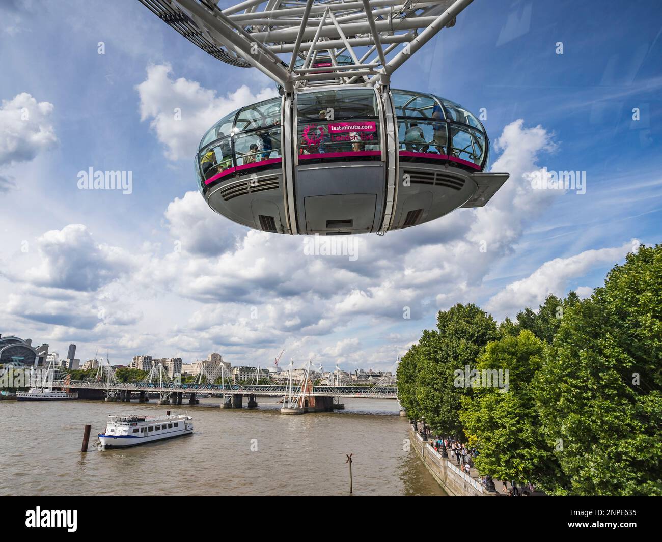 Guardando sotto una capsula sul London Eye mentre inizia a ruotare su Londra, i turisti possono vivere un'esperienza unica sopra il Tamigi. Foto Stock